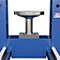 Forklift tire press with a roll-in table for loading and unloading parts
